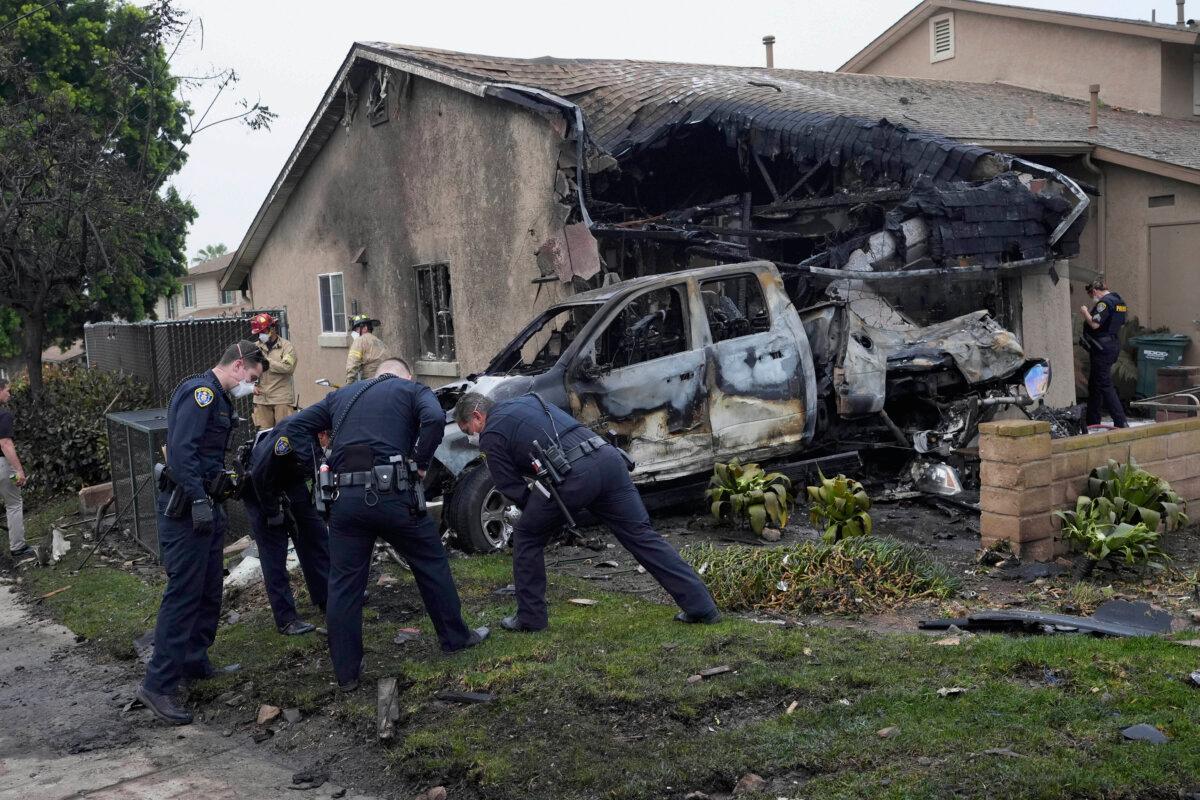 Authorities work at the scene where a small plane crashed into a San Diego neighborhood on May 22, 2025 (Gregory Bull/AP Photo)