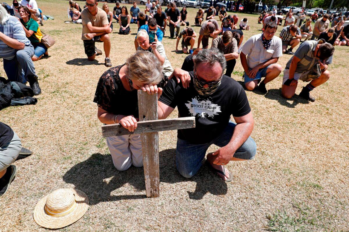 Farmers kneel as they pray during their protest against farm murders and attacks in Pretoria, South Africa, on Oct. 10, 2020. (Phill Magakoe/AFP via Getty Images)