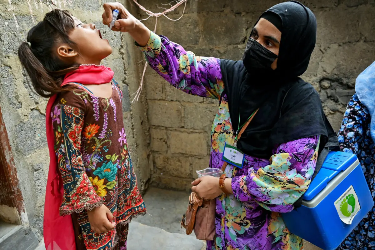A health worker administers polio drops to a child for vaccination on the first day of a nationwide week-long poliovirus eradication campaign in Karachi, Pakistan, on May 26, 2025. (Asif Hassan/AFP via Getty Images)