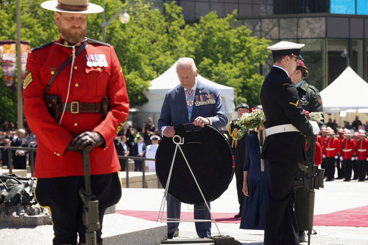 King Charles and Queen Camilla lay a wreath at The Tomb of the Unknown Soldier at the National War Memorial in Ottawa on May 27, 2025. (Patrick Doyle/POOL/AFP via Getty Images)