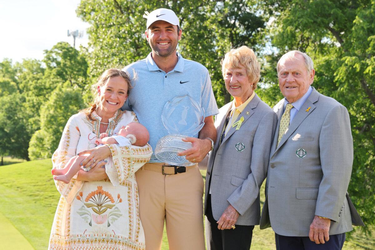 (L-R) Meredith Scheffler, Bennett Scheffler, Scottie Scheffler of the United States, Jack Nicklaus, and Barbara Nicklaus pose with the trophy after Scheffler won the Memorial Tournament presented by Workday at Muirfield Village Golf Club in Dublin, Ohio, on June 9, 2024. (Michael Reaves/Getty Images)