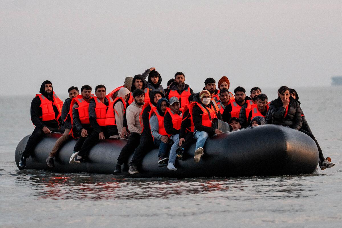 Migrants sit on a dinghy as they prepare to sail into the English Channel on May 31, 2025, in Gravelines, France. (Carl Court/Getty Images)