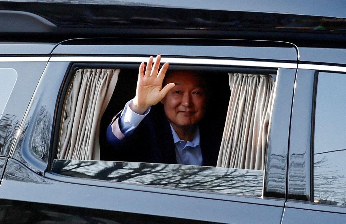 Ousted former South Korean President Yoon Suk Yeol gestures from a vehicle as he returns to his former residence in an apartment complex in Seoul, on April 11, 2025. (Kim Soo-hyeon/Reuters)
