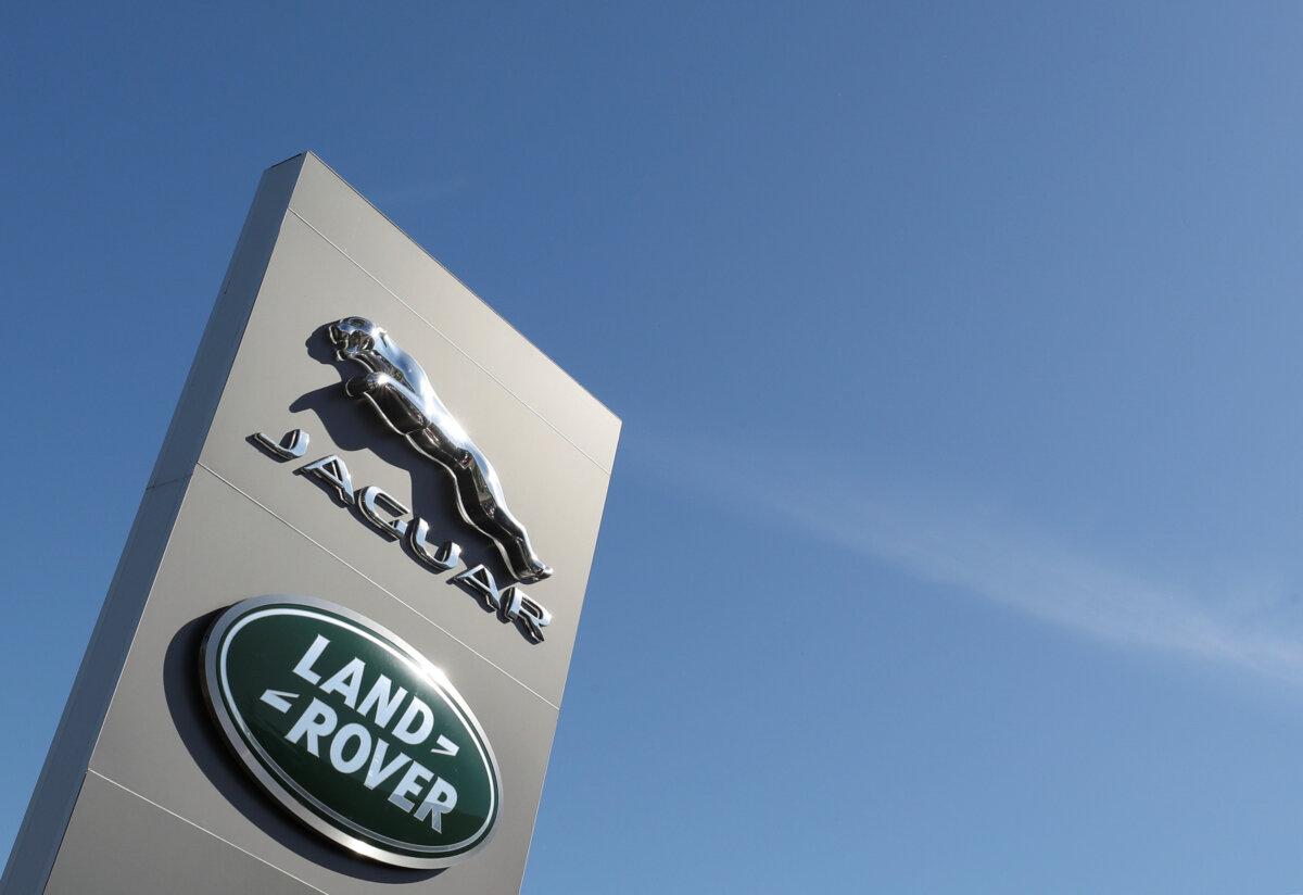 Logos of Jaguar and Land-Rover outside a car dealer in Brussels on May 28, 2020. (Yves Herman/Reuters)
