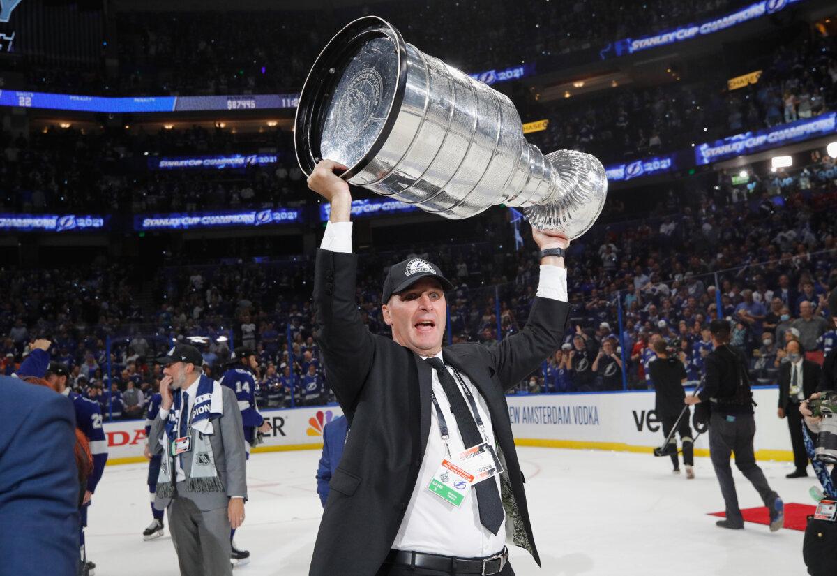 Mathieu Darche lifts the Stanley Cup after the Tampa Bay Lightning defeated the Montreal Canadiens at the Amalie Arena in Tampa, Fla., on July 7, 2021. (Bruce Bennett/Getty Images)
