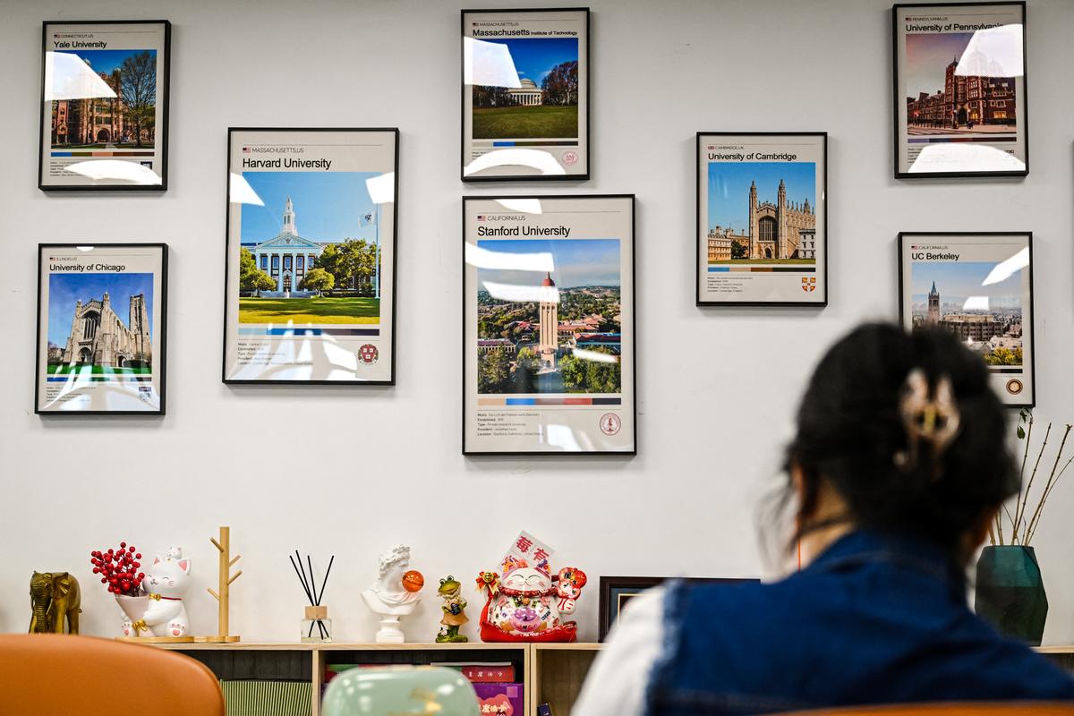 Posters of U.S. universities, including Harvard University, are displayed at an overseas education agency in Beijing on May 29, 2025. (Jade Gao/AFP via Getty Images)
