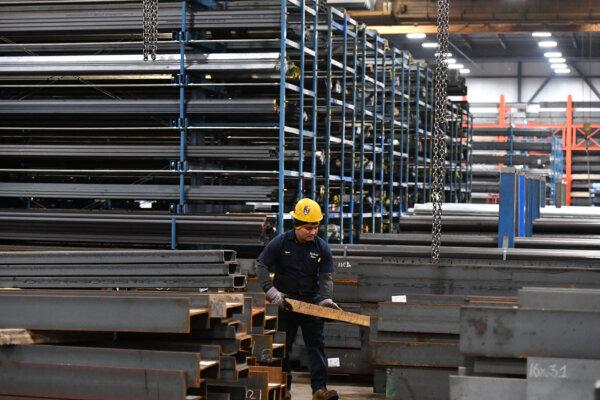 A worker prepares to lift a steel beam with a crane at Central Steel Supply Company in Marlborough, Mass., on March 13, 2025. (Joseph Prezioso/AFP)