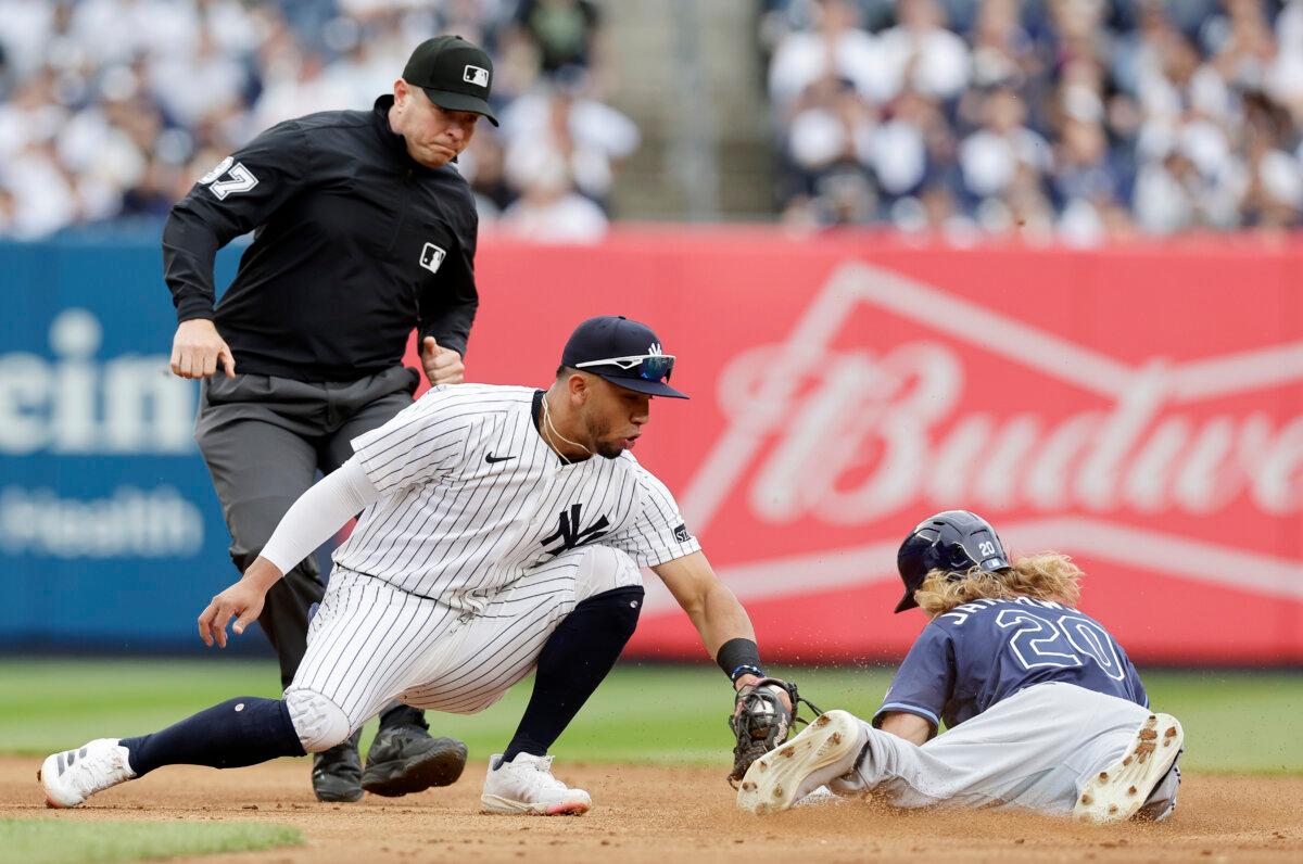 Travis Jankowski of the Tampa Bay Rays beats the tag from Oswald Peraza of the New York Yankees for a stolen base during the second inning at Yankee Stadium in New York City on May 4, 2025. (Jim McIsaac/Getty Images)