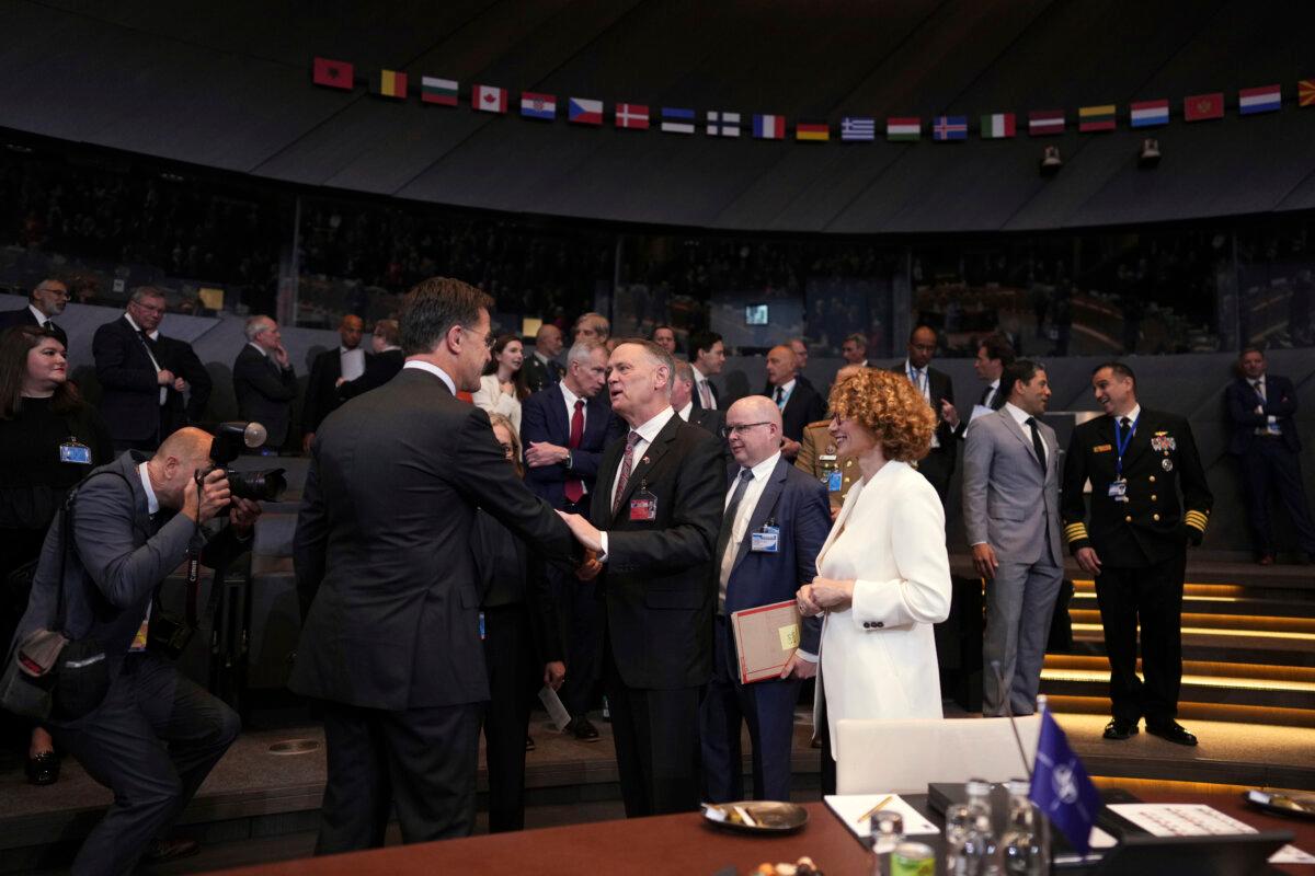 NATO Secretary General Mark Rutte (center left), speaks with Defence Minister David McGuinty, center, during a meeting of NATO defence ministers at NATO headquarters in Brussels on June 5, 2025. (AP Photo/Virginia Mayo)