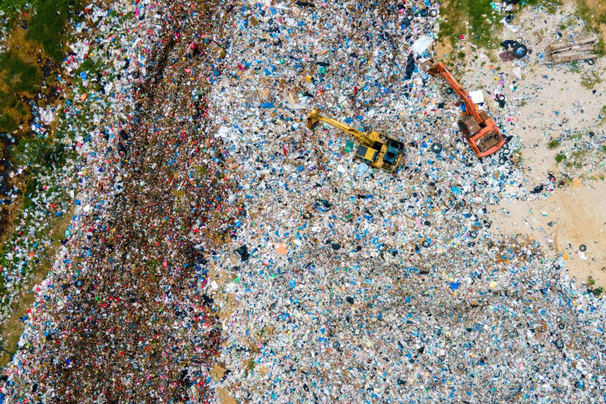 An aerial view of workers using excavators at a landfill in Banda Aceh, Indonesia, on June 5, 2025. (Chaideer Mahyuddin/AFP via Getty Images)