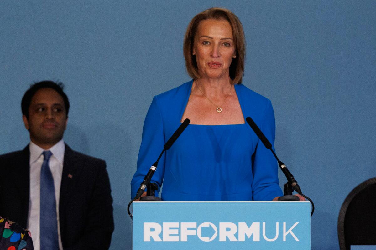 Zia Yusuf is sitting behind Sarapochin speaking at the Reform UK press conference held in London on May 27, 2025 (Dunkitwood/Getty Images)