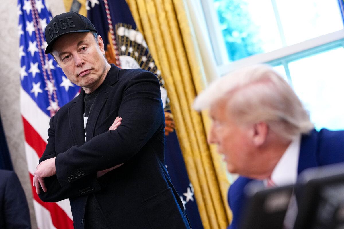 Tesla Shares Slip After Second-Quarter Earnings Results as Auto Revenues Fall Again | USNN World News Tesla CEO Elon Musk listens as President Donald Trump speaks to reporters in the Oval Office of the White House in Washington, on May 30, 2025. (Kevin Dietsch/Getty Images)