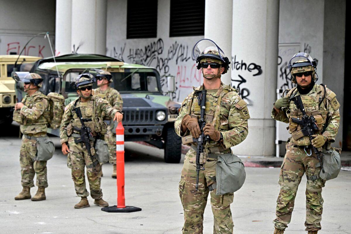 Members of the National Guard stand guard outside the Metropolitan Detention Center, MDC in downtown Los Angeles, California on June 8, 2025. (Photo by Frederic J. Brown / AFP)