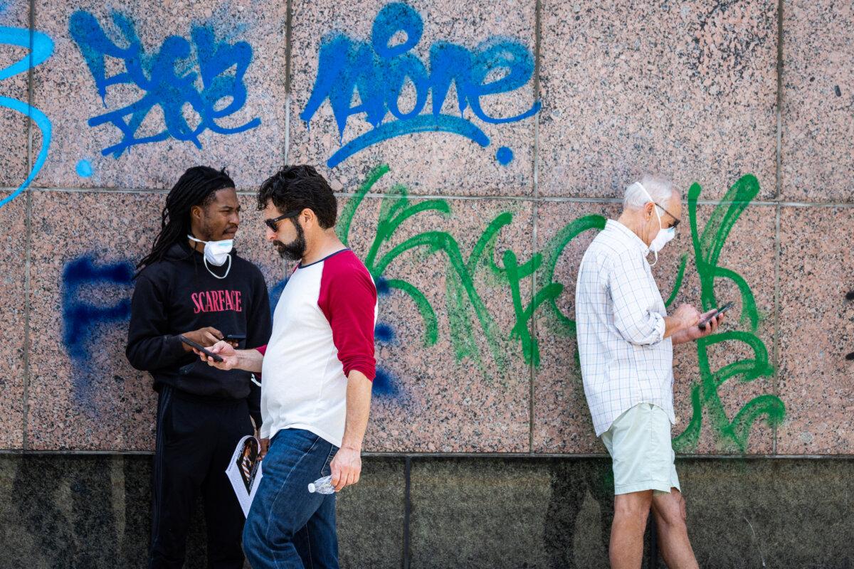 Anti-ICE graffiti sprayed on the walls of a federal building in Los Angeles on June 8, 2025. (John Fredricks/The Epoch Times)
