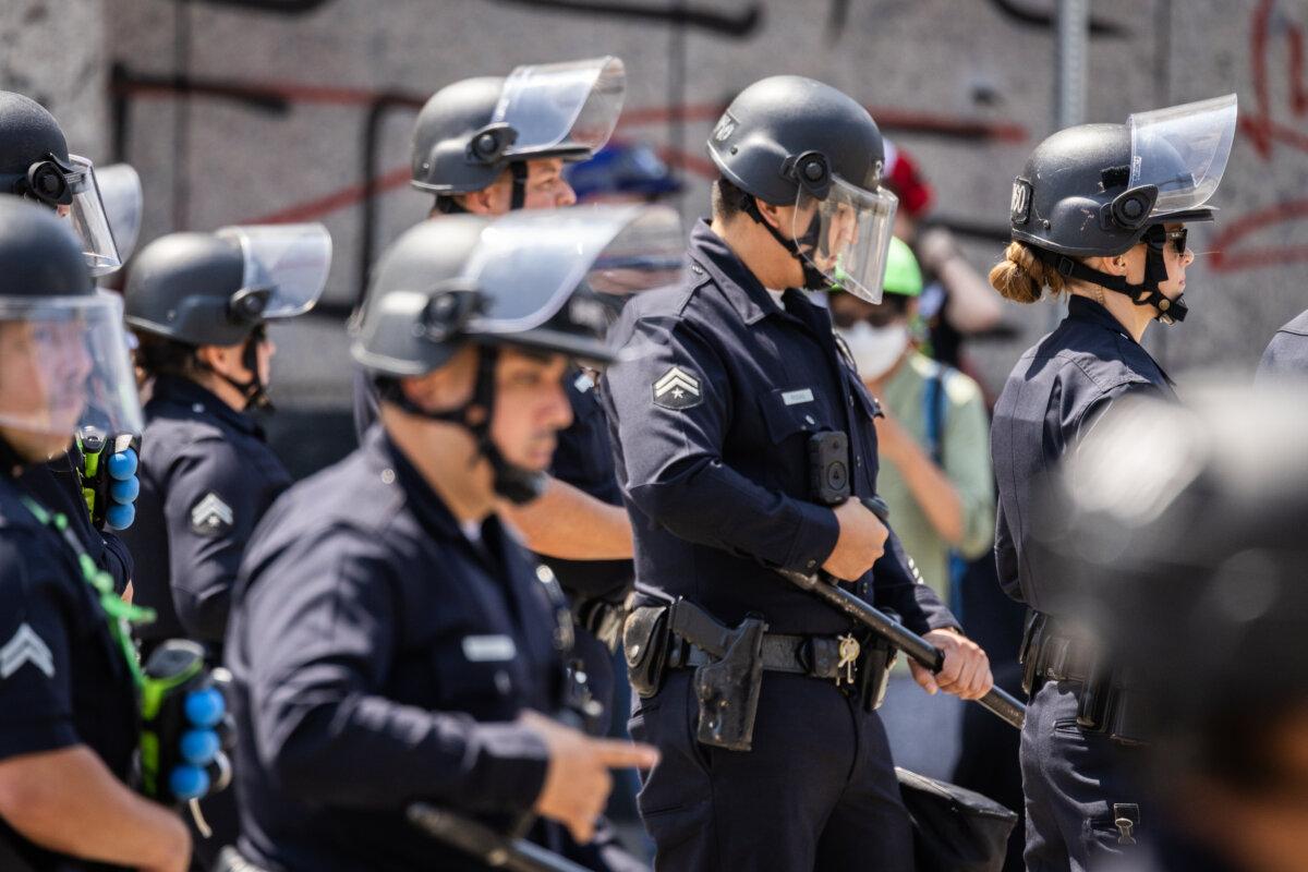 Police officers block a road leading to a federal facility in downtown Los Angeles on June 9, 2025. (John Fredricks/The Epoch Times)