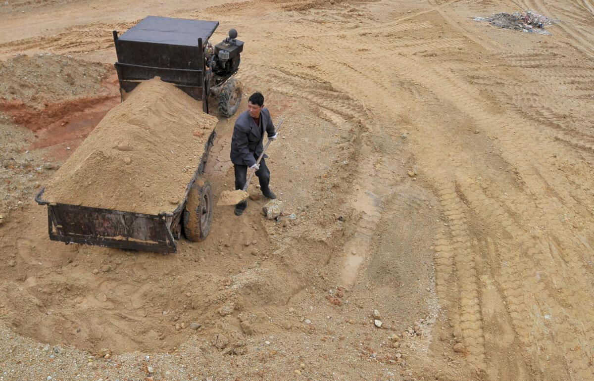 A laborer works at a site of a rare earth metals mine in Jiangxi Province, China, on March 14, 2012. (Stringer/File Photo/Reuters)