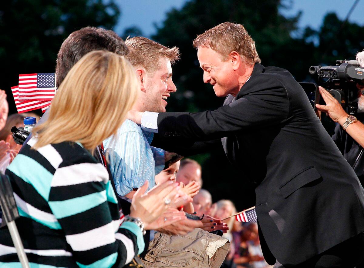 Sinise talks with Marine Sgt. John Peck backstage at the 25th National Memorial Day Concert on May 25, 2014, in Washington, D.C. (Paul Morigi/Stringer/Getty Images)