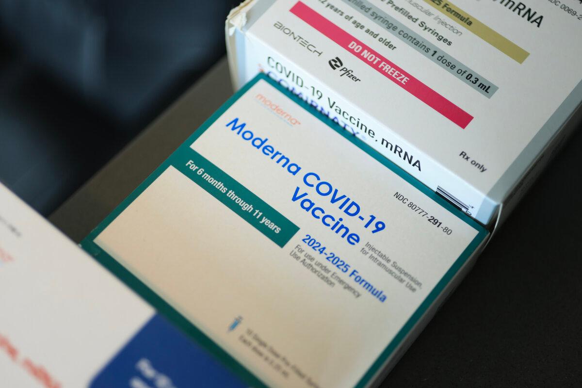 Pfizer-BioNTech COVID-19 (top) and Moderna COVID-19 vaccines sit in boxes at Borinquen Health Care Center on May 29, 2025 in Miami, Florida. (Joe Raedle/Getty Images)