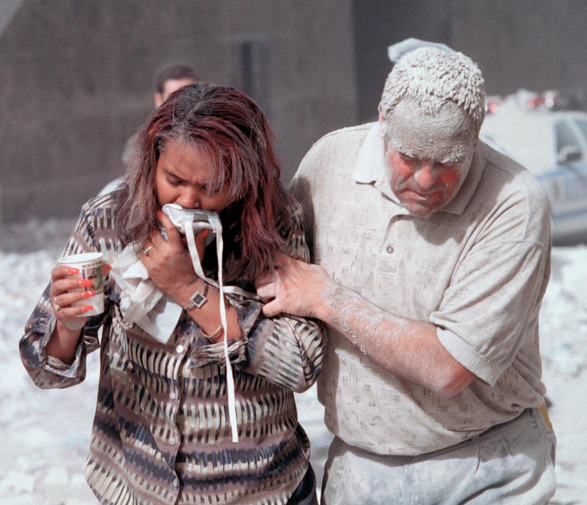 Survivors covered in dust after the collapse of the World Trade towers. (Public Domain)