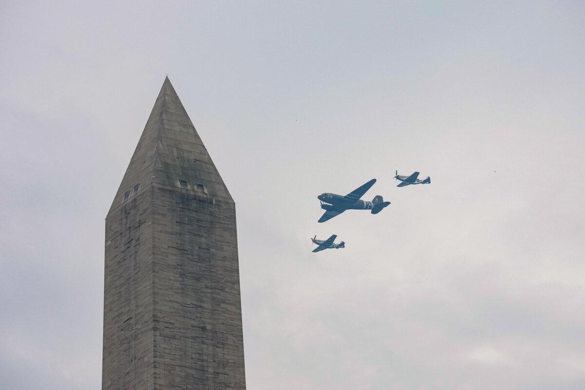 A U.S. Army C-47 Skytrain and P-51 fly past the Washington Monument during the military parade in Washington on June 14, 2025. (Kevin Dietsch/Getty Images)