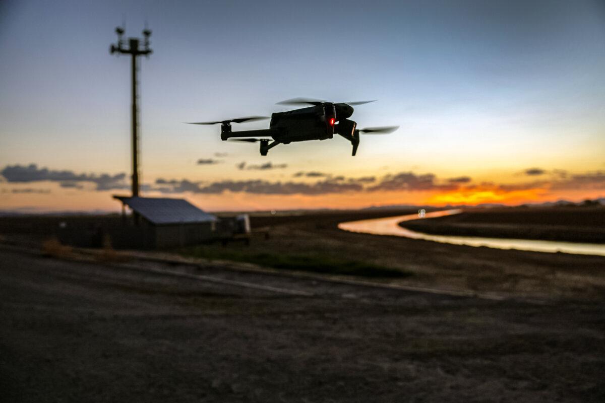 A DJI Mavic 3 drone flies past a U.S. government surveillance tower near the U.S.–Mexico border in Yuma, Ariz., on Sept. 27, 2022. (John Moore/Getty Images)