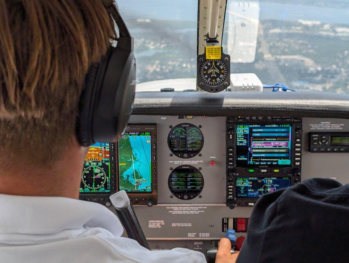Justin Gorrell (L) and Aldo Costa (R), both flight instructors at Universal Flight Training in Sarasota, Fla., conduct a flight training session for Gorrell on May 29, 2025, with the small Piper aircraft's instruments on display. (Jacob Burg/The Epoch Times)