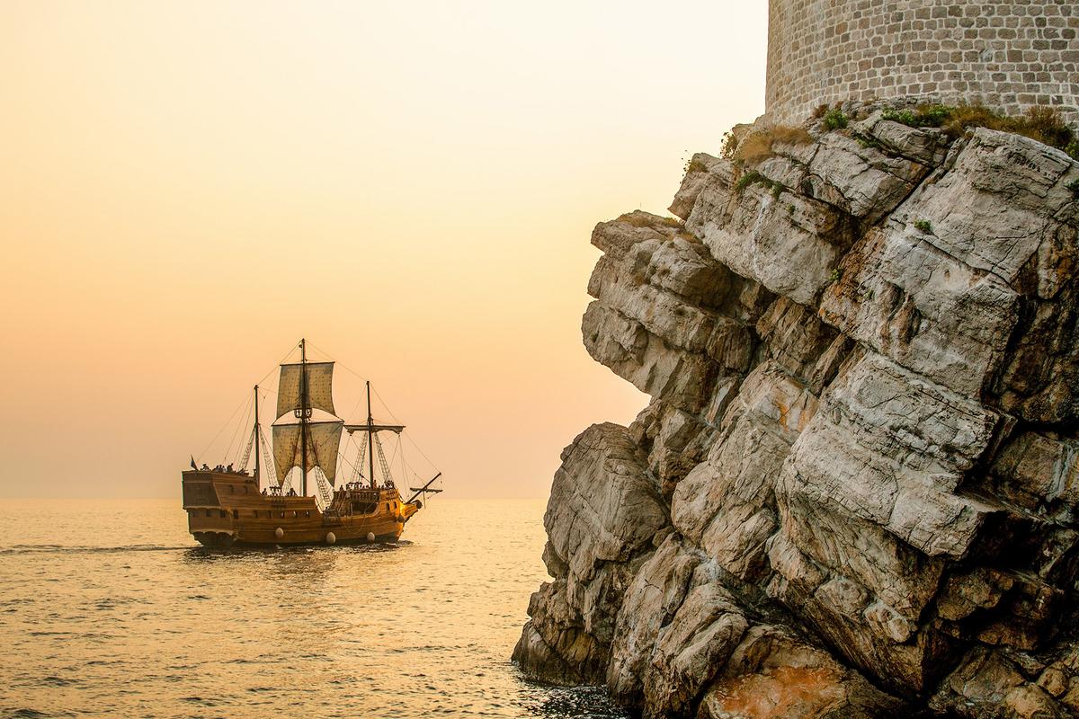 A ship sails during sunset at the Old City Harbor. (Hector John Periquin/Unsplash)