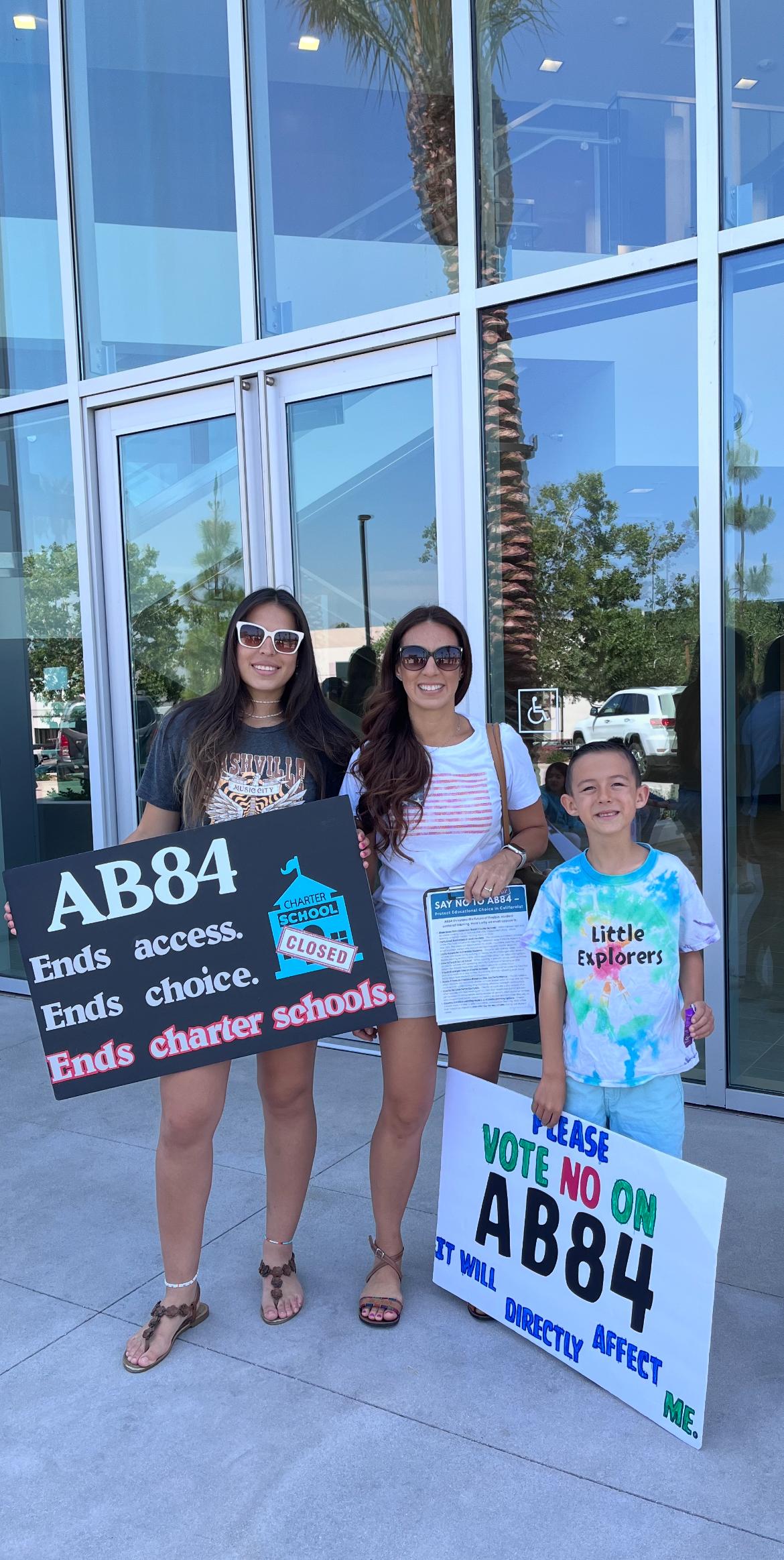 Stephanie Dawson (C) and her children, Celeste (L) and Nicholas (R), attend a rally to oppose AB 84, in California on June 23, 2025. (Courtesy of Stephanie Dawson)