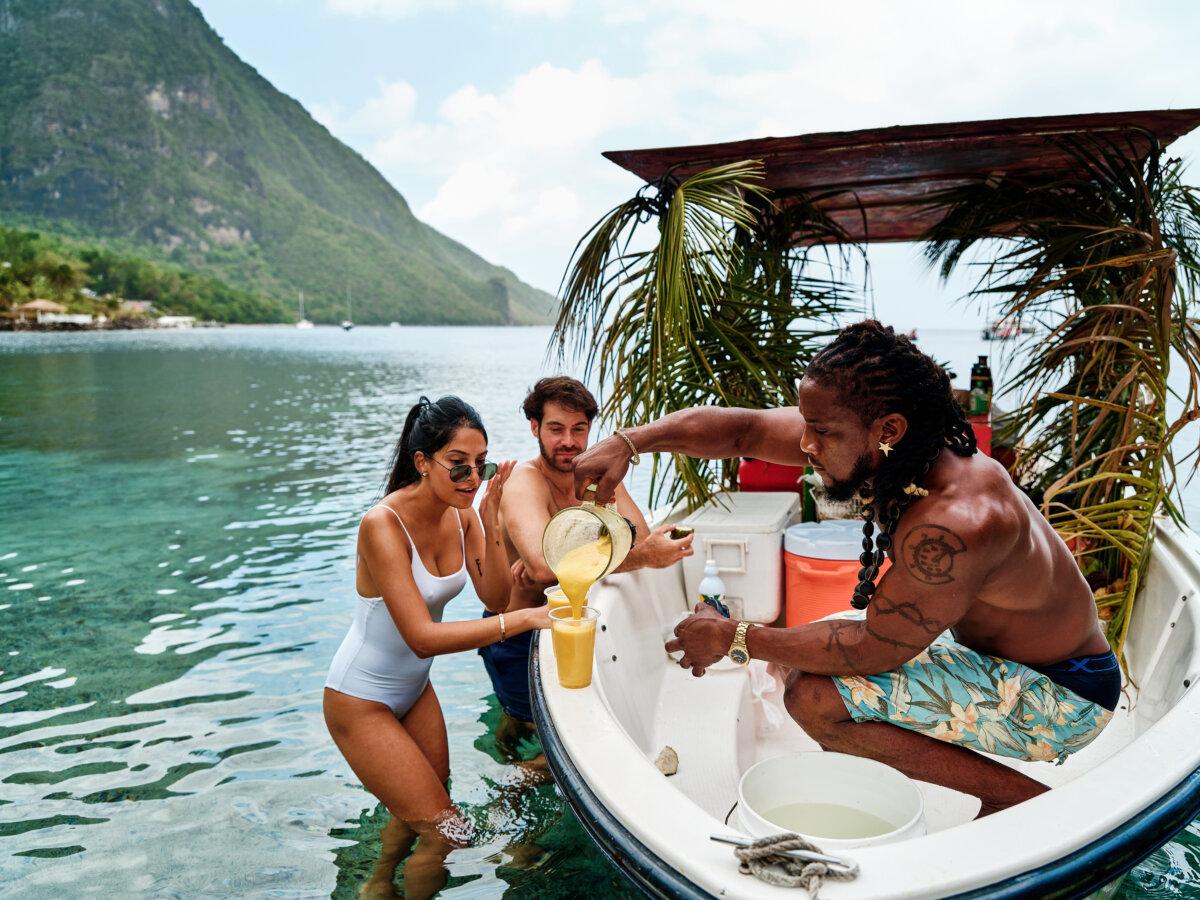Vacationers enjoy tropical, boat-side smoothies while enjoying the waters of St. Lucia. (Ollie Jones/Saint Lucia Tourism Authority/TNS)