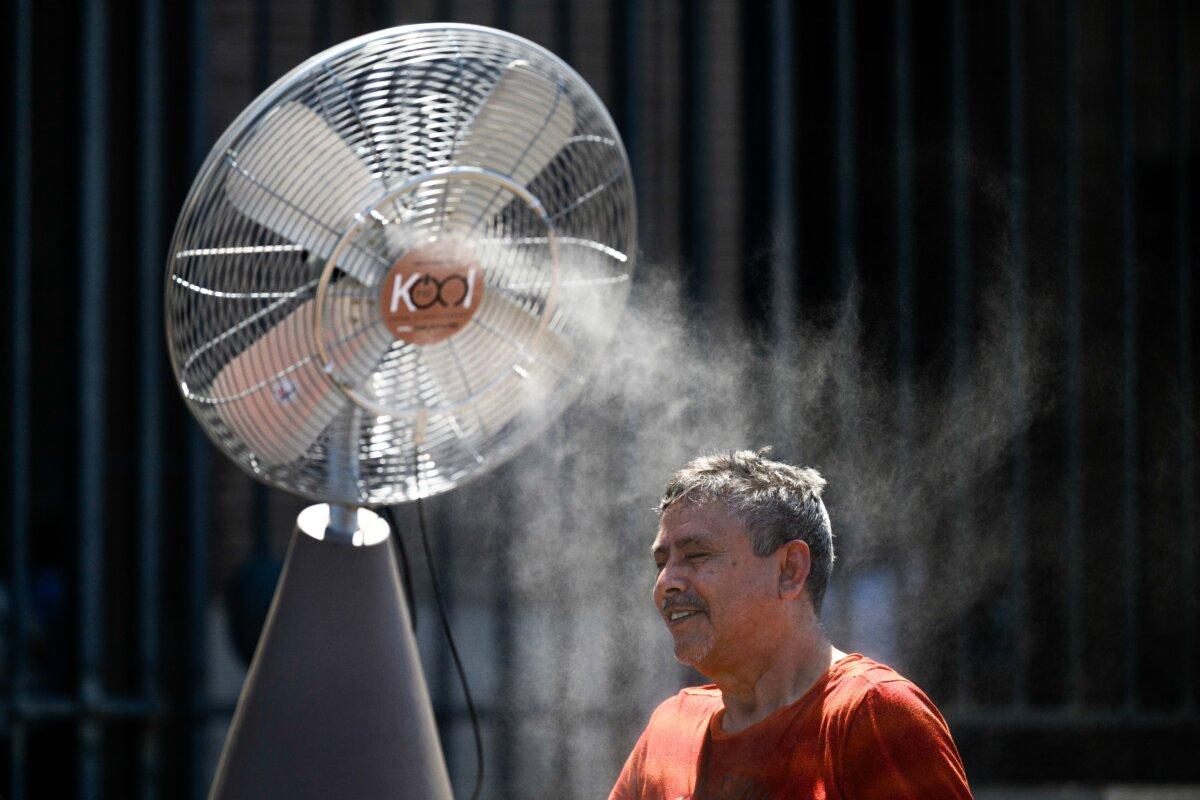A man cools down with a fan during an ongoing heat wave in Rome, Italy, on July 1, 2025. (Antonio Masiello/Getty Images)