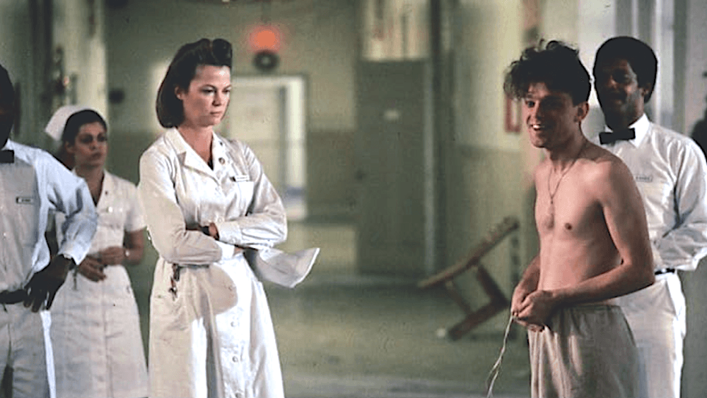 Nurse Ratched (Louise Fletcher) about to shame the shirtless Billy Bibbitt into committing suicide, in "One Flew Over the Cuckoo's Nest." (United Artists)