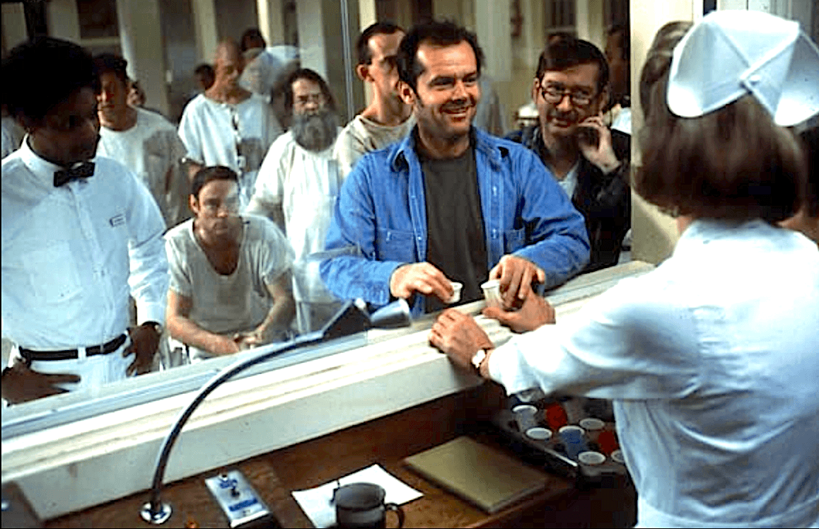 Randle P. McMurphy (Jack Nicholson, in blue) hassles Nurse Ratched (Louise Fletcher) whenever he gets the opportunity, in "One Flew Over the Cuckoo's Nest." (United Artists)