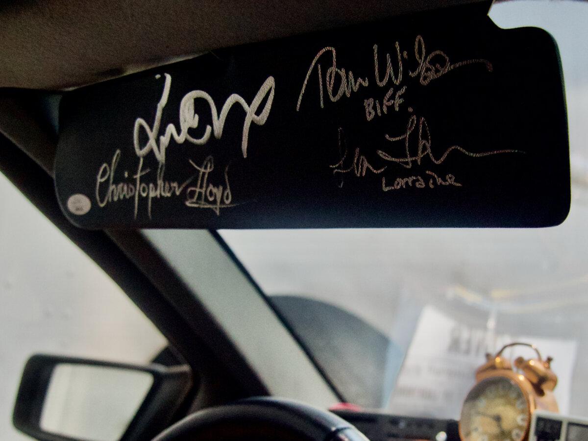 The driver's side visor of the Franchi family's DeLorean "time machine" is autographed by cast members Michael J. Fox, Christopher Lloyd, Tom Wilson, and Lea Thompson, on July 1, 2025. (Travis Gillmore/The Epoch Times)