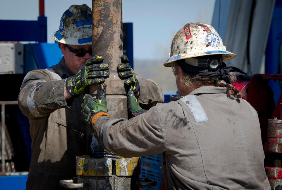 Workers change pipes at a gas drilling rig exploring the Marcellus Shale outside Waynesburg, Pa., in a file photo. (Mladen Antonov/AFP via Getty Images)