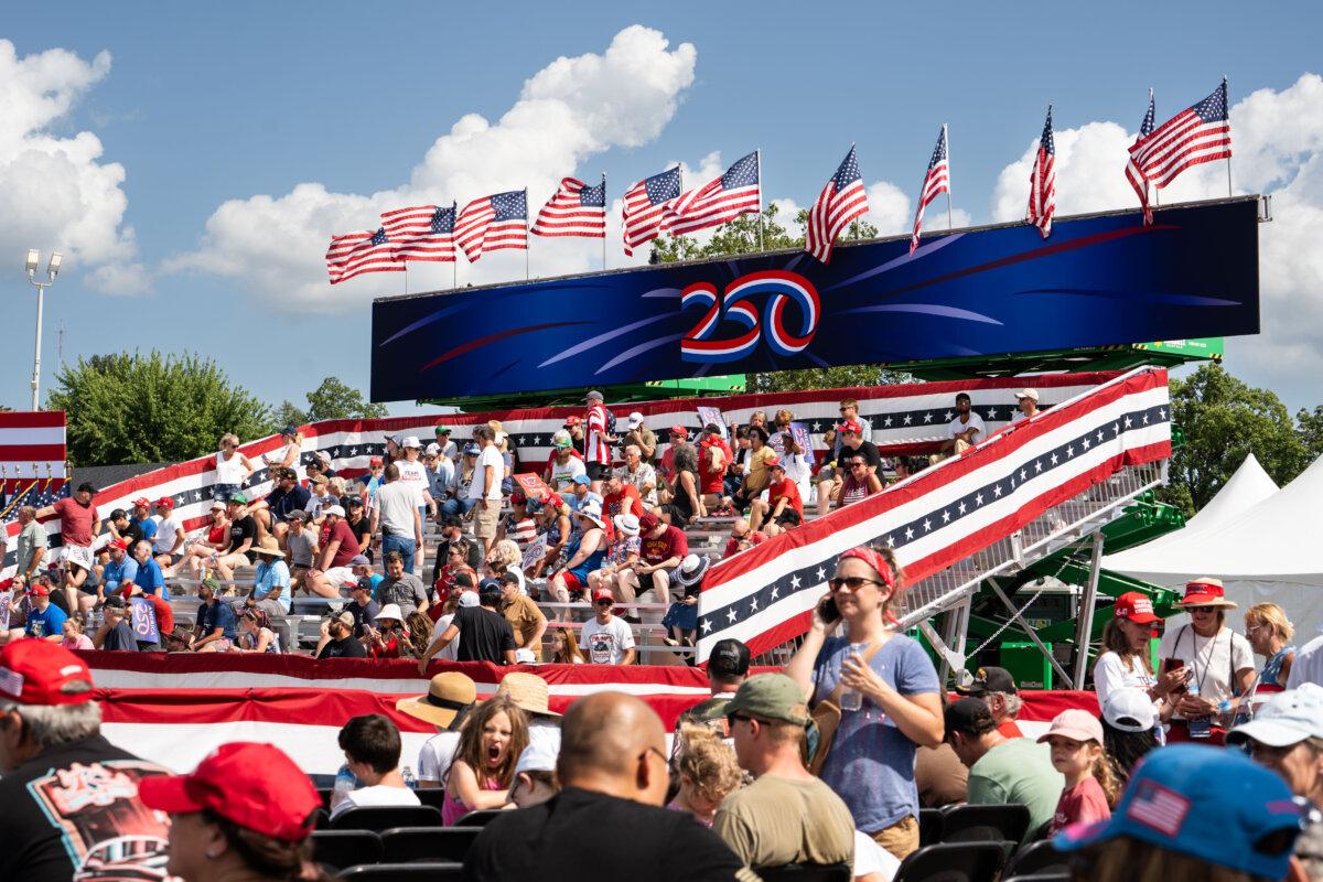 People wait at the Iowa State Fairgrounds ahead of President Donald Trump’s remarks marking the beginning of a year of festivities before the 250th anniversary of the signing of the Declaration of Independence, in Des Moines, Iowa, on July 3, 2025. (Madalina Kilroy/The Epoch Times)