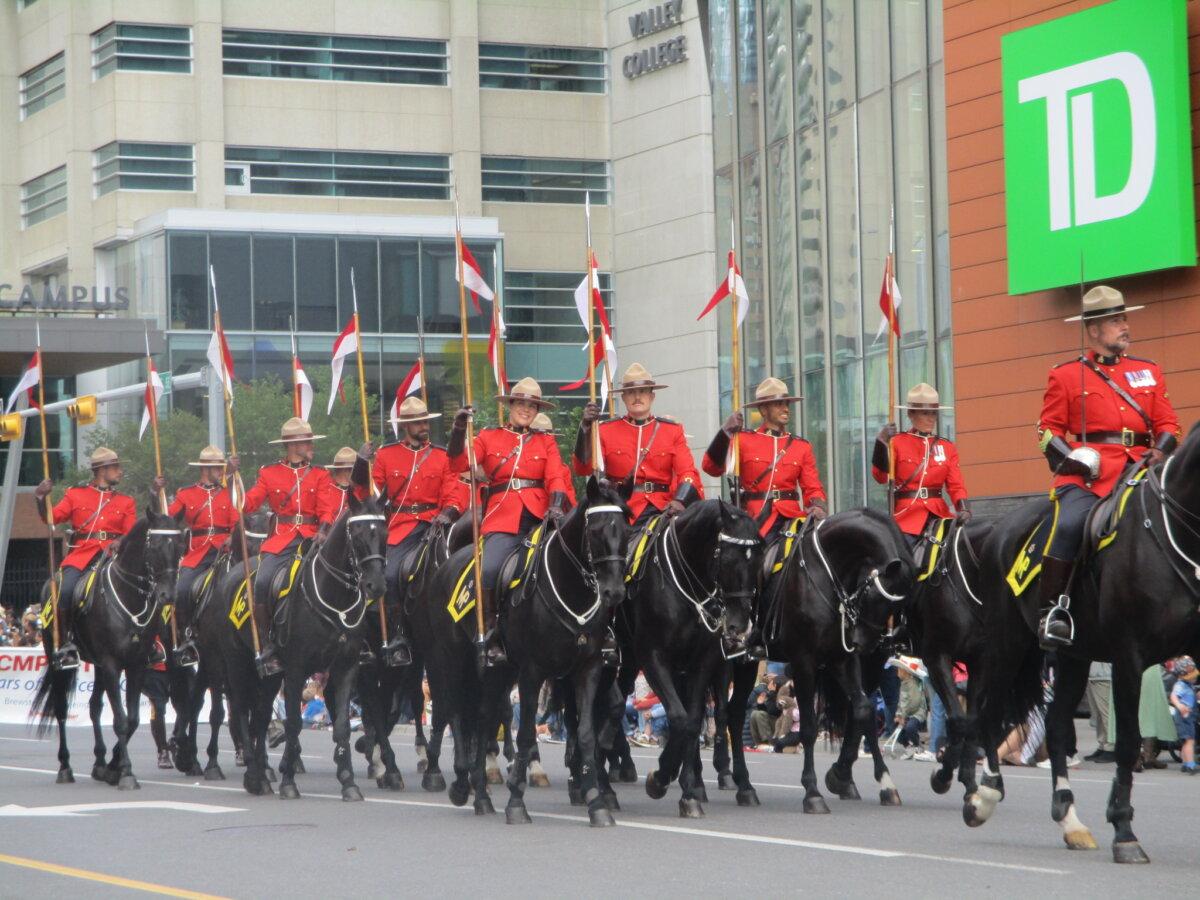 RCMP officers take part in the Stampede parade in Calgary on July 4, 2025. (Maple Lynn/The Epoch Times)