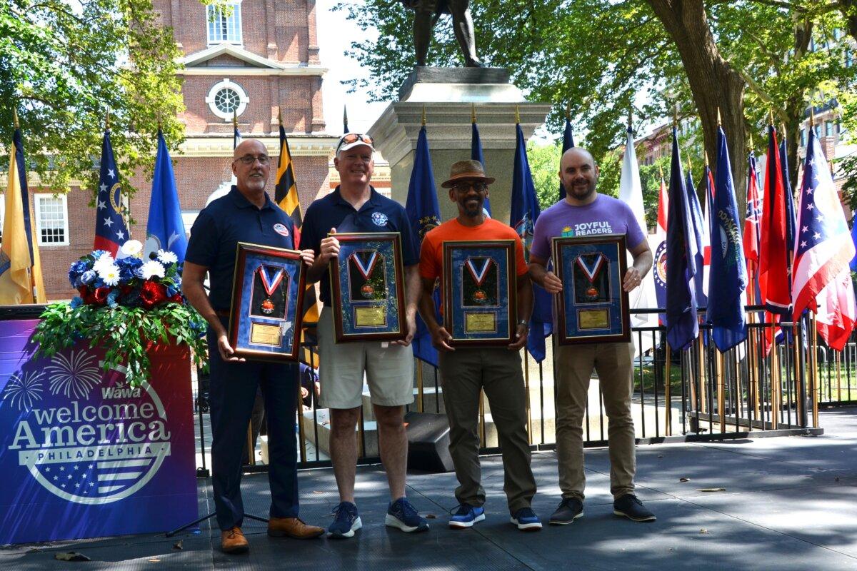 At Philadelphia’s Celebration of Freedom Ceremony, the 2025 Wawa Foundation Hero Award recipients stand proudly, on July 4, 2025. From left: award runner-up Joe Brooks, executive director of Veterans Multi-Service Center; award winner Bob White, president of Families Behind the Badge Children’s Foundation; award runner-up Sean Vereen, president of Heights Philadelphia; and award runner-up Dave Weinstein, founder of Joyful Readers. (Frank Liang/The Epoch Times)