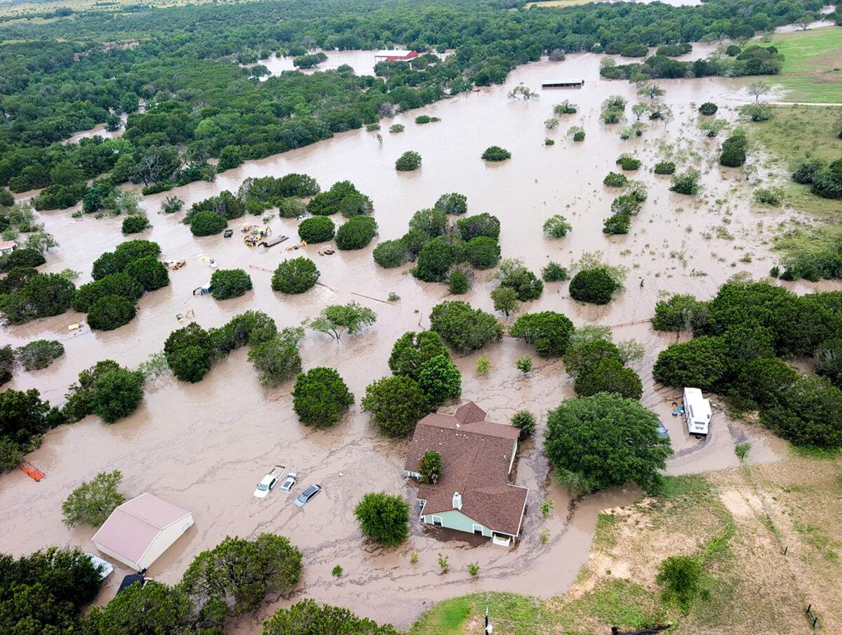 Houses and cars are partially submerged in flood waters in an aerial view near Kerrville, Texas, on July 4, 2025. (U.S. Coast Guard/Handout via Reuters)