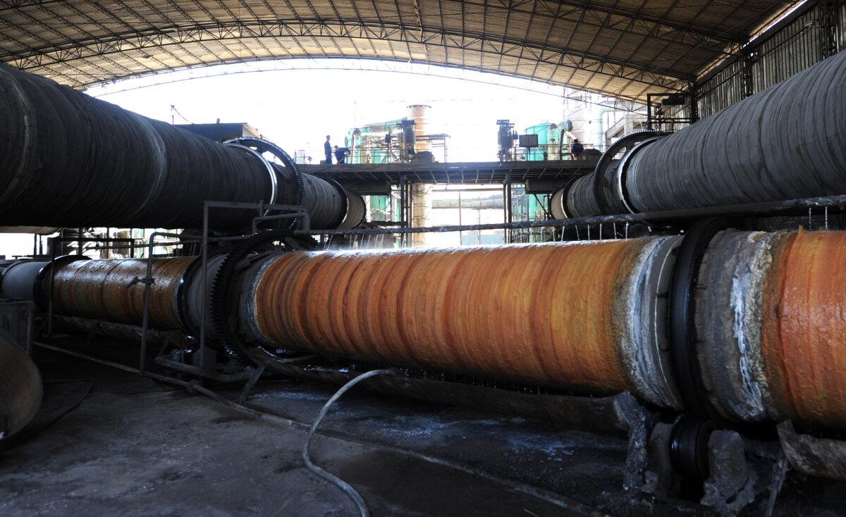 Rare earths undergoing processing in large steel pipes are cooled off with dripping water at a factory in Baotou City, Inner Mongolia, on April 21, 2011. (Frederic J. Brown/AFP via Getty Images)