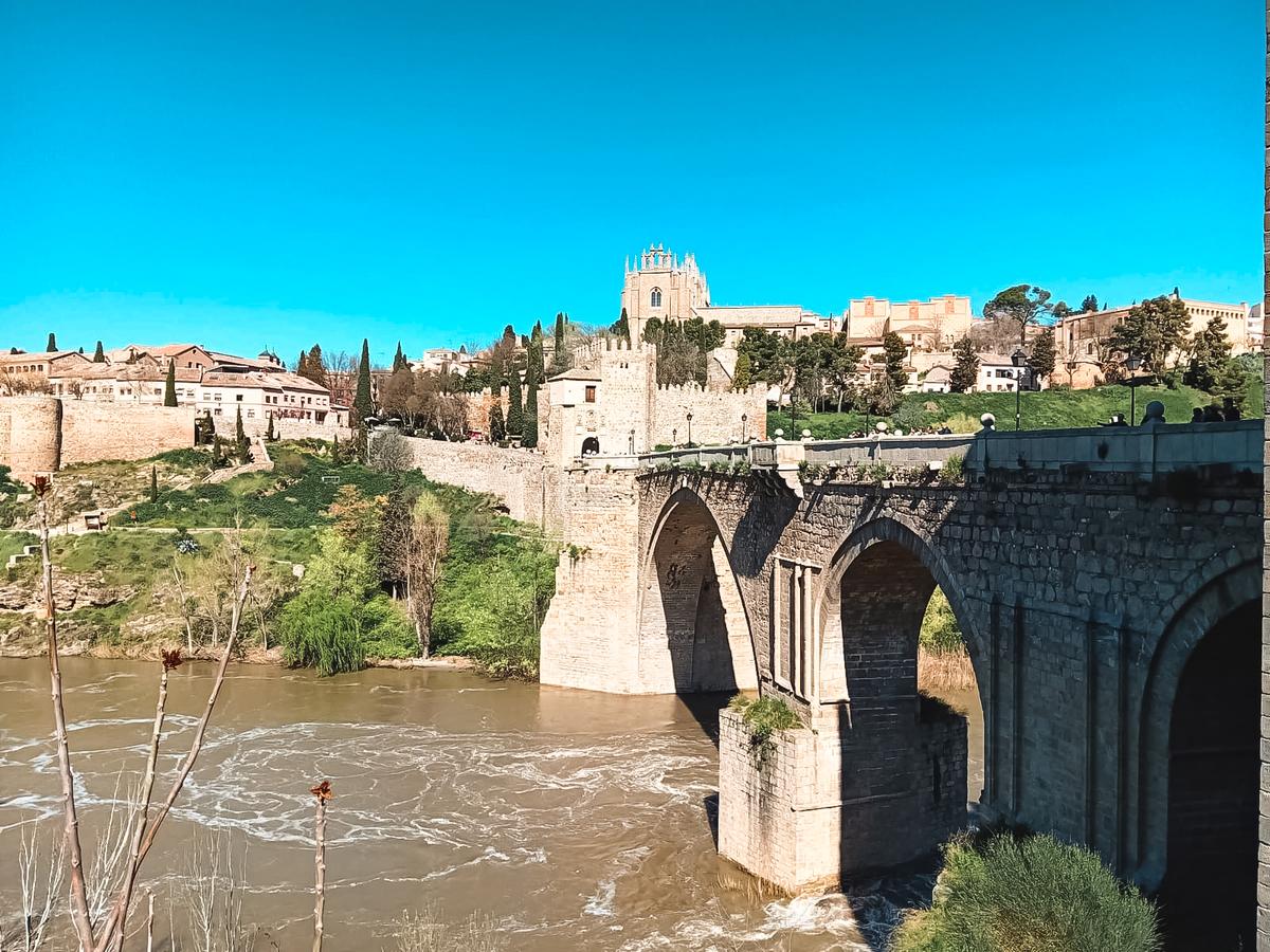 The 14th-century San Martín Bridge crosses the Tagus River. Fortified gates and defensive towers protect both ends of the bridge. (Autumn Spredermann)