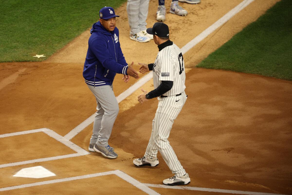 Managers Dave Roberts of the Los Angeles Dodgers and Aaron Boone of the New York Yankees greet each other on the field before Game Three of the 2024 World Series at Yankee Stadium in the Bronx on Oct. 28, 2024. (Elsa/Getty Images)