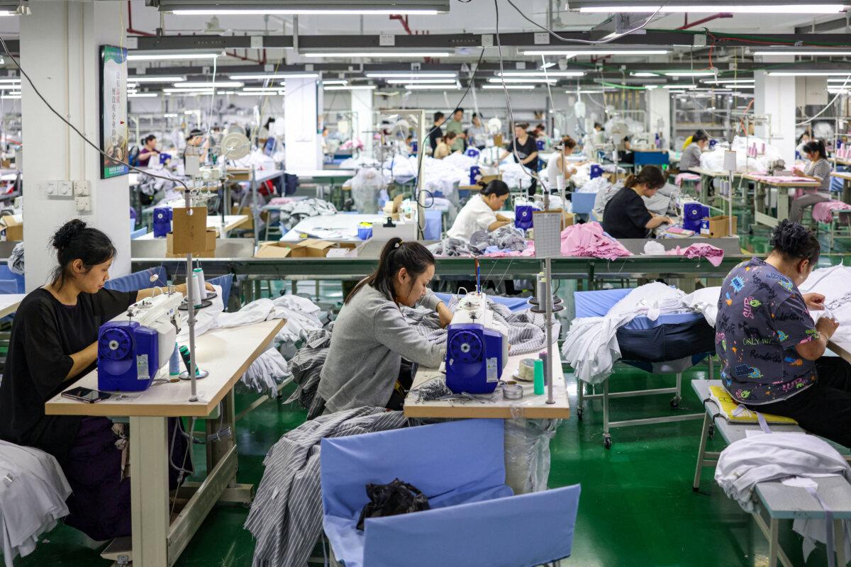 Employees sew clothes for export at a clothing factory in Tongren, China, on May 15, 2025. (STR/AFP via Getty Images)