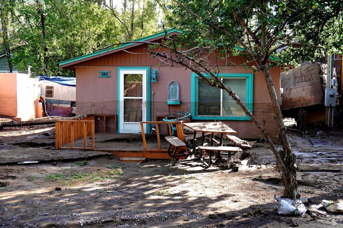 A single-family home along the banks of the Rio Ruidoso in Ruidoso, N.M., sustained severe damage during a flash flood on July 8, 2025. (Allan Stein/The Epoch Times)