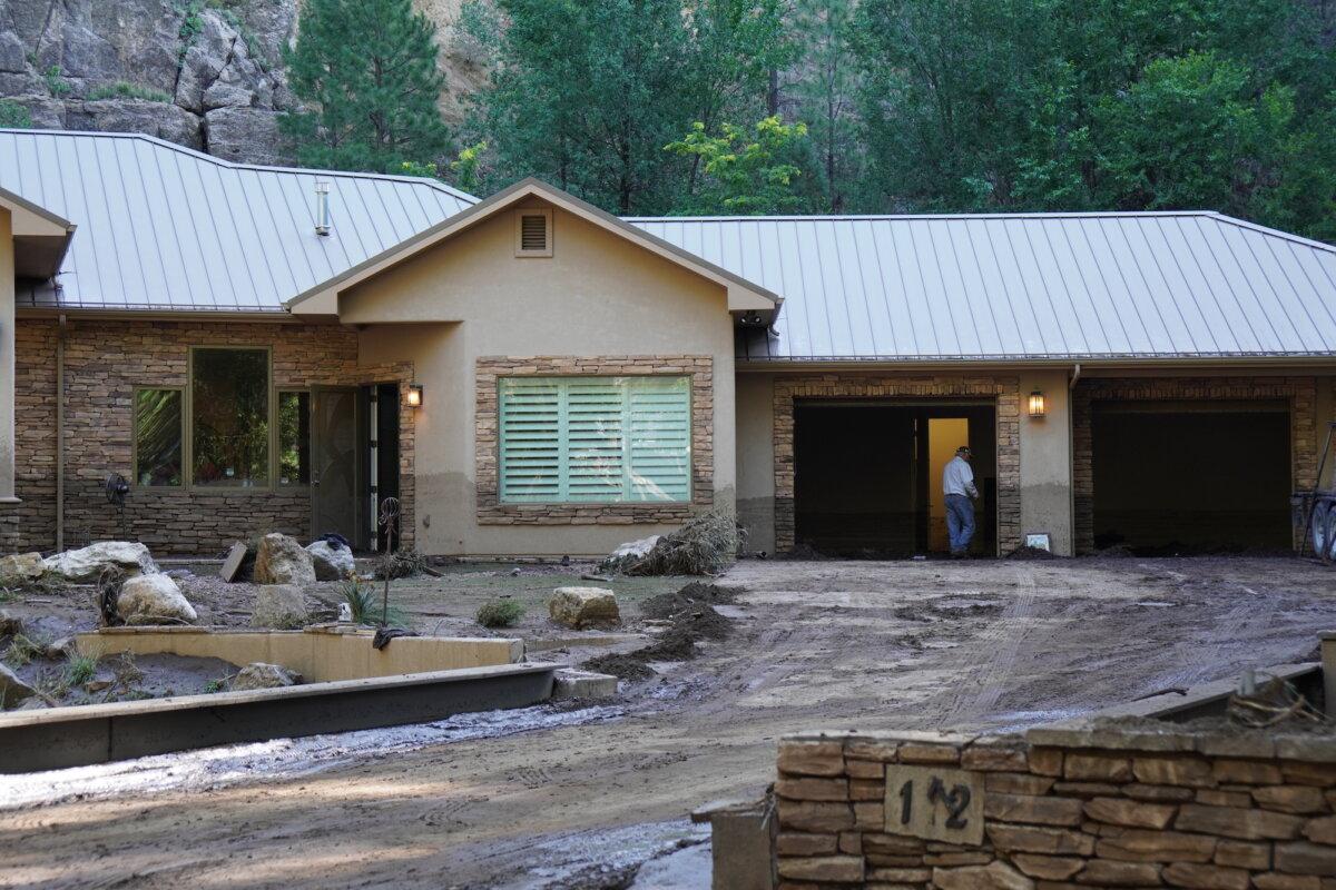 A man assesses the damage inside a home ravaged by a flash flood in Ruidoso, N.M., on July 8, 2025. Photo taken on July 10, 2025. (Allan Stein/The Epoch Times)