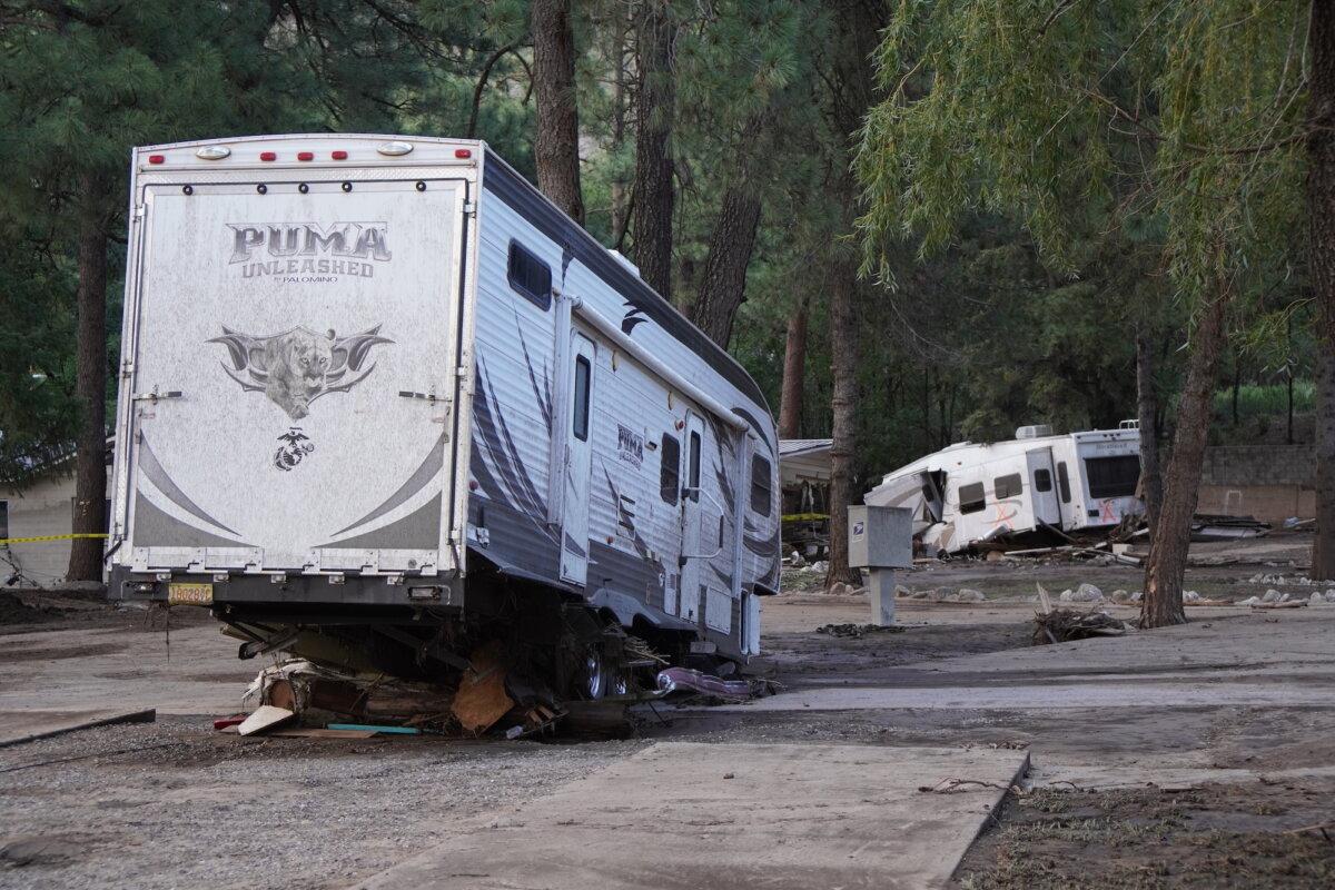 Mobile homes sit at unusual angles after being struck by rising floodwaters in the village of Ruidoso, N.M., on July 8, 2025. (Allan Stein/The Epoch Times)