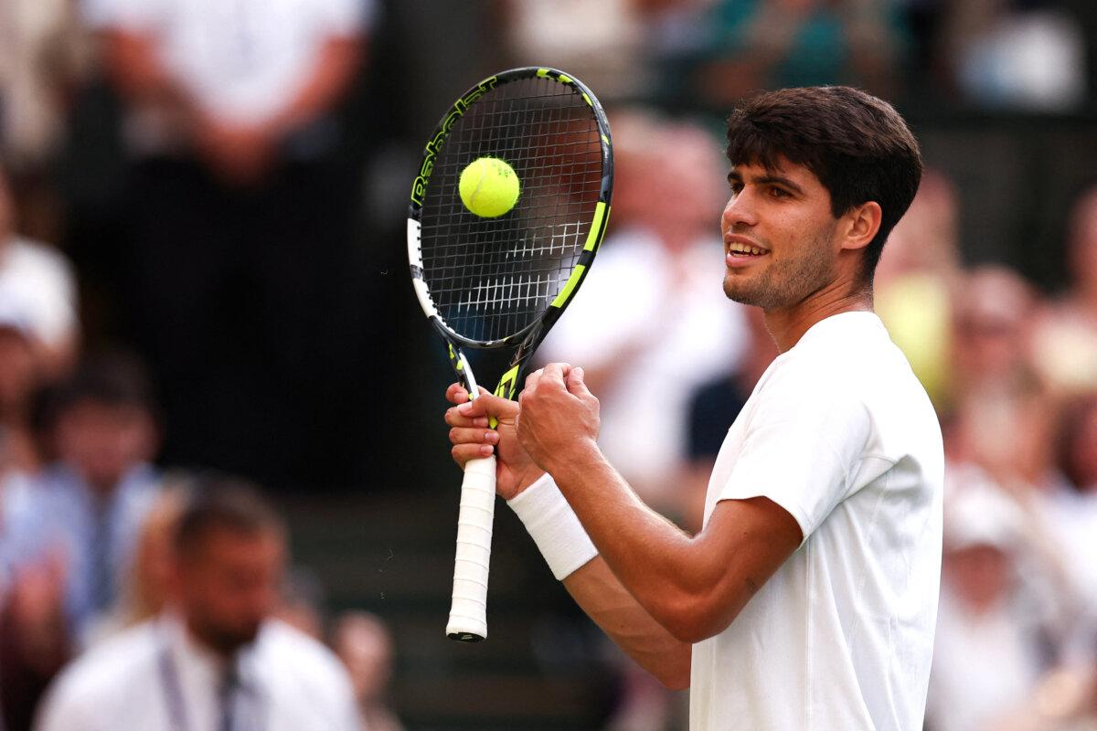 Jannik Sinner Beats 2-time Defending Champion Carlos Alcaraz to Win His First Wimbledon Title 2 Spain's Carlos Alcaraz reacts as he plays against Italy's Jannik Sinner during their men's singles final tennis match on the fourteenth day of the 2025 Wimbledon Championships at The All England Lawn Tennis and Croquet Club in Wimbledon, southwest London, on July 13, 2025. (Henry Nicholls/AFP via Getty Images)