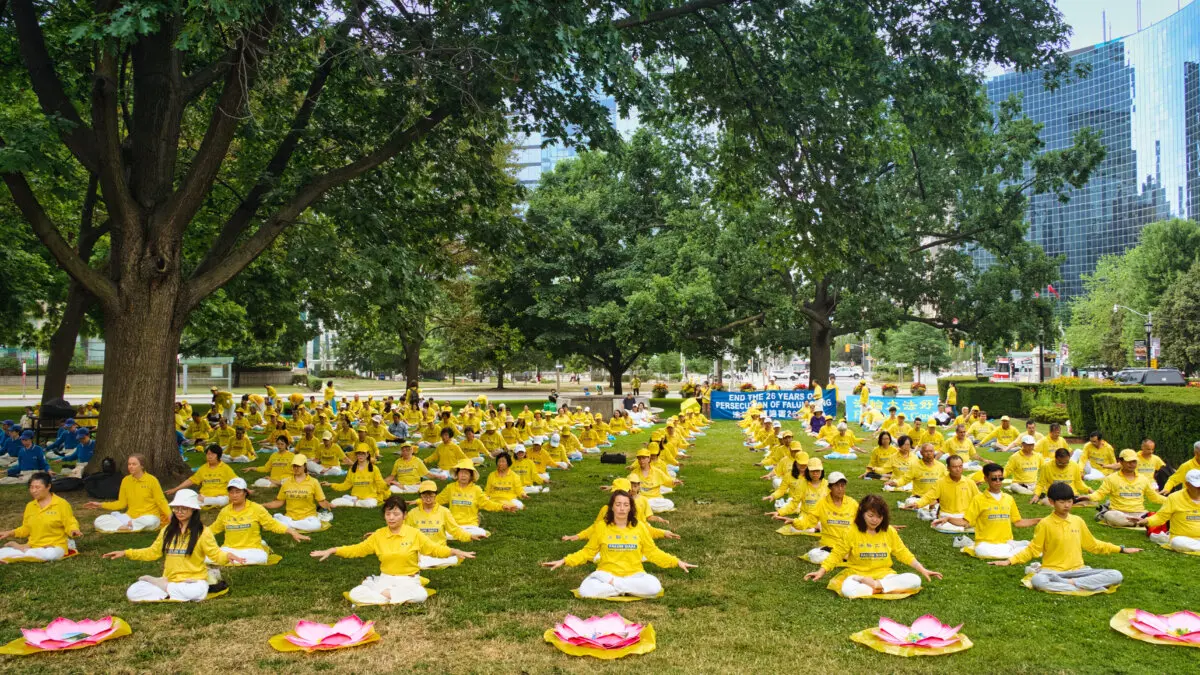 Falun Gong practitioners demonstrate the practice's meditative exercises at Queen's Park in Toronto on July 13, 2025, during an event to commemorate the 26th anniversary of the CCP's persecution campaign against Falun Gong. (Jerry Zhang/The Epoch Times)