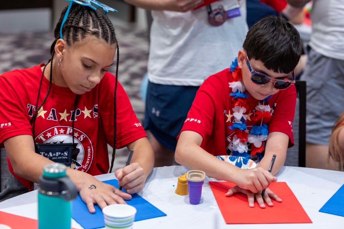 During Memorial Day weekend, each participant at TAPS’s camp event draws a silhouette of their hand and crafts a message in remembrance of their loved one. (Courtesy of TAPS)
