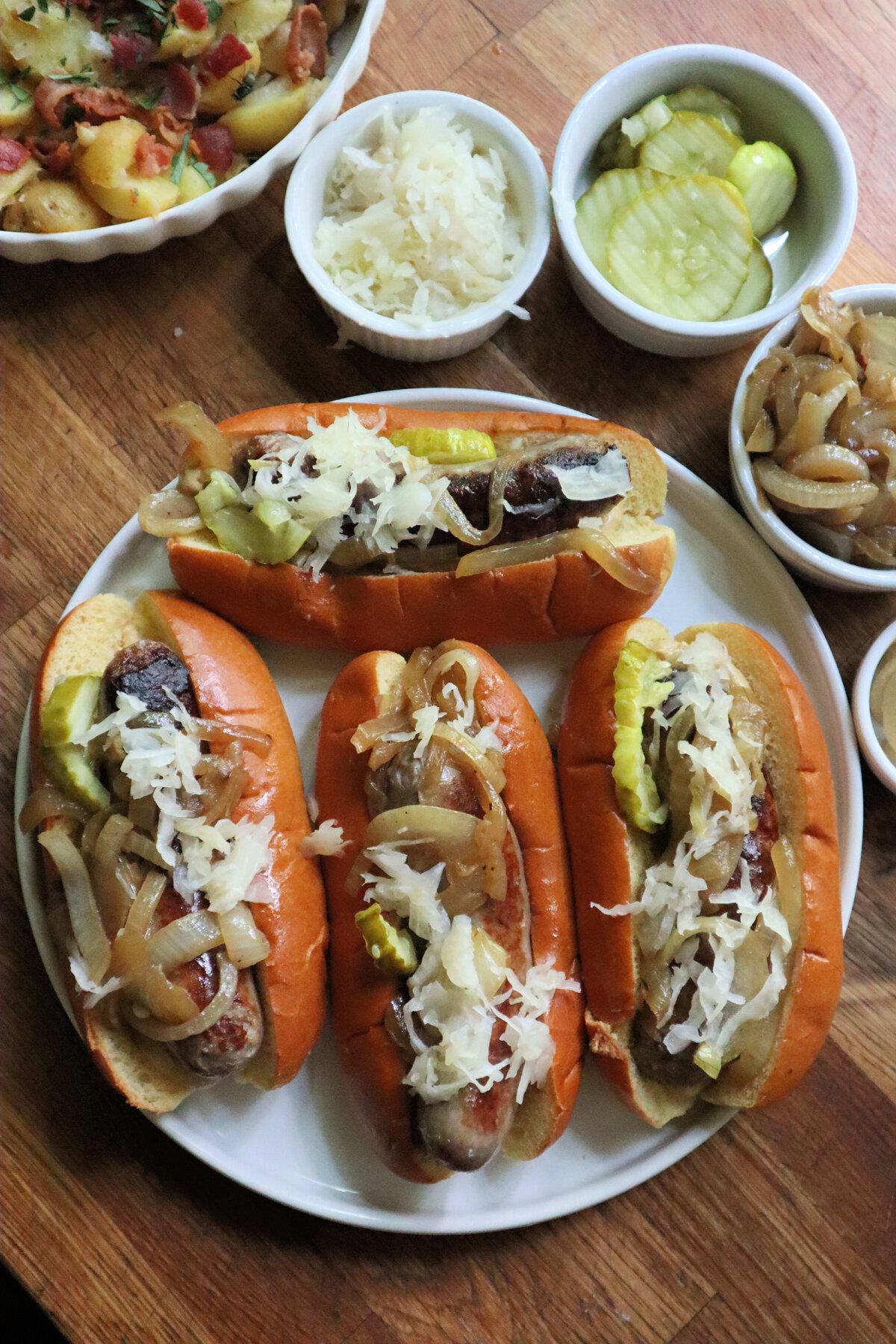 The headliner in this budget dinner for four is bratwurst cooked with onion in beer, served in a bun with sauerkraut and mustard. Pickles optional. (Gretchen McKay/Pittsburgh Post-Gazette/TNS)
