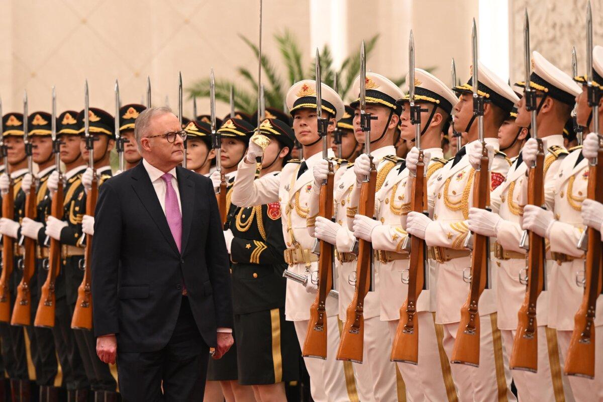 Prime Minister Anthony Albanese inspects the Honour Guard as part of a six-day diplomatic visit in the Great Hall of the People in Beijing, China on July 15, 2025.(AAP Image/Lukas Coch)
